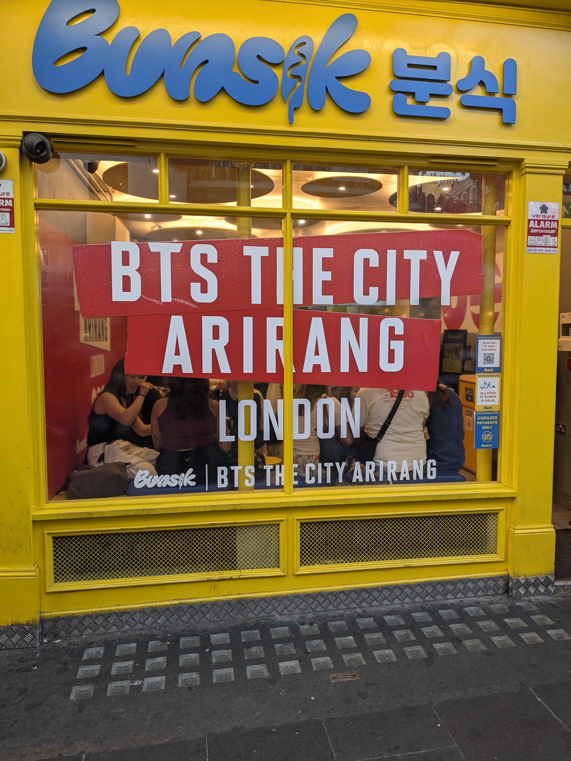 Bunsik Leicester Square storefront with BTS The City Arirang window graphic